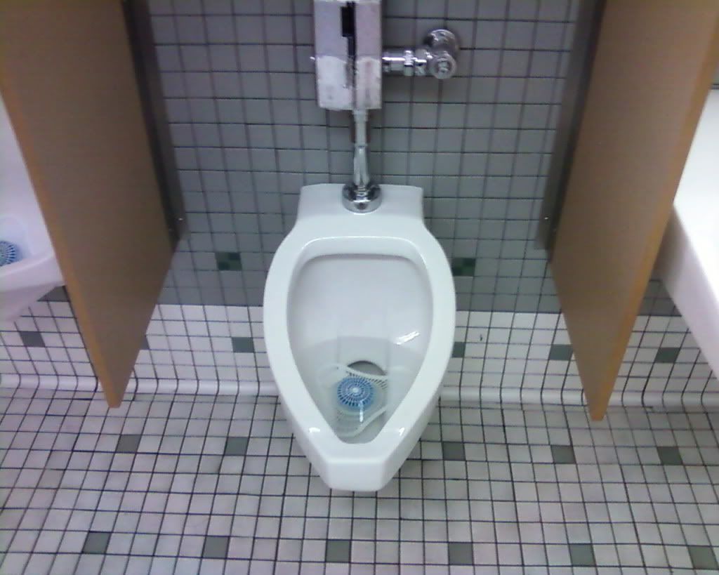 men peeing into urinals
